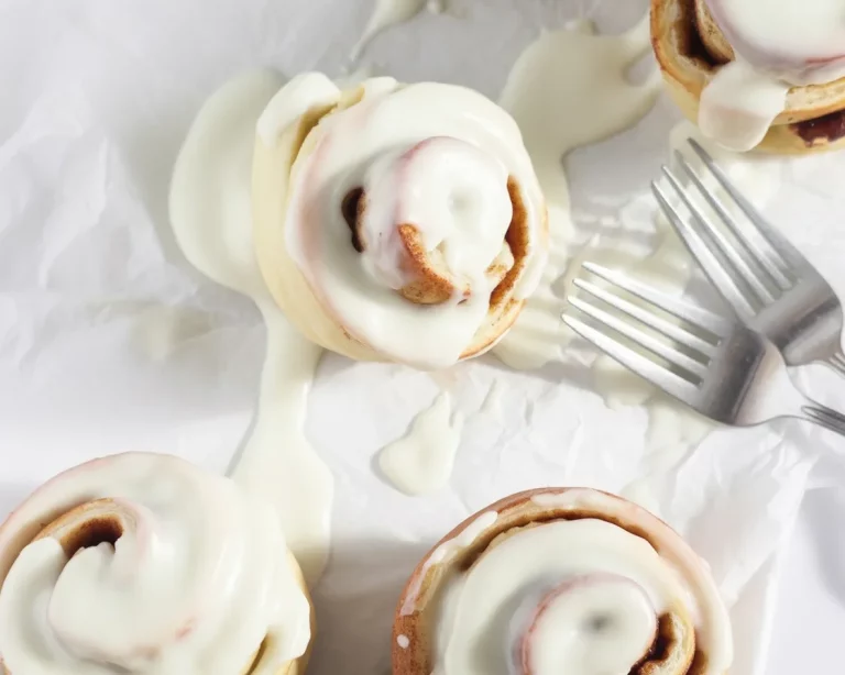 Freshly baked small batch cinnamon rolls without yeast on a wooden table.
