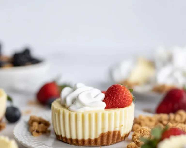 Small batch Greek yogurt berry cheesecake cups topped with fresh berries.