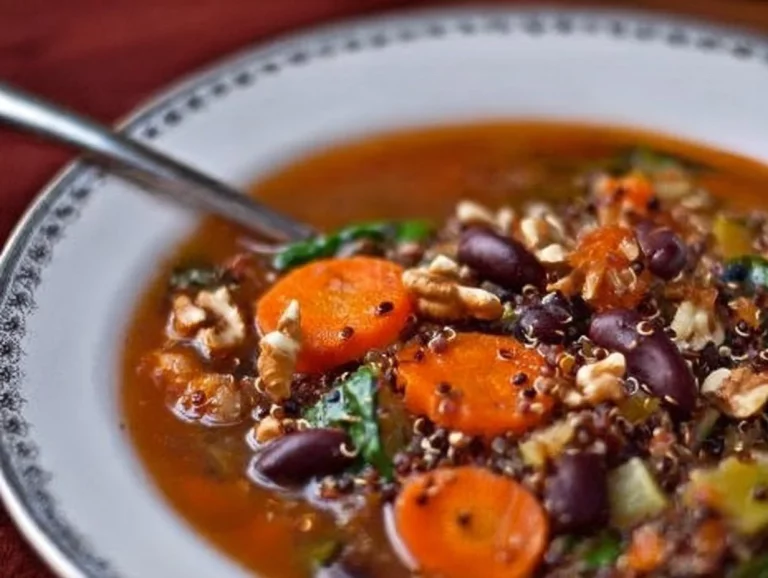 Bowl of hearty holiday soup for the soul, served with festive garnishes.