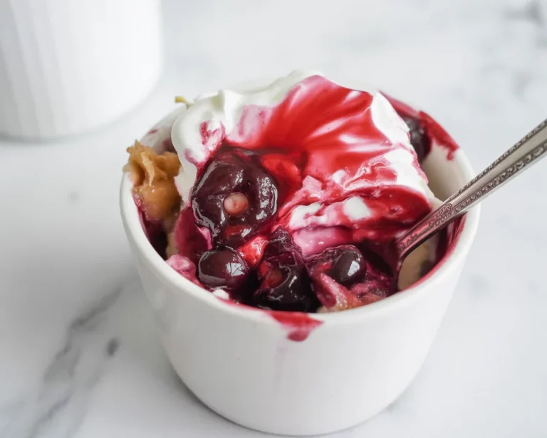 Small Batch Cherry Crumble in a mini baking dish with oatmeal topping and fresh cherries.
