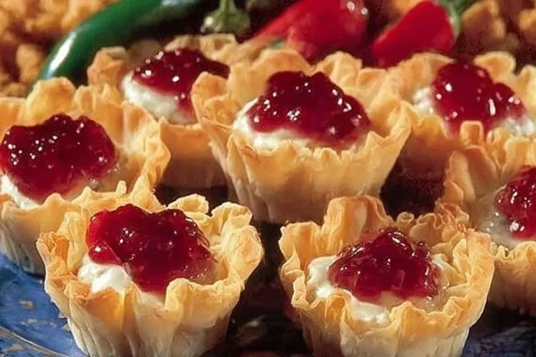 Cranberry appetizers with crab meat and cream cheese served on a platter