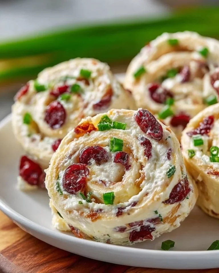Pineapple cranberry cream cheese party pinwheels on a serving platter.