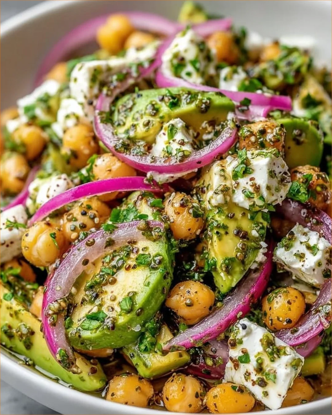 Chickpea Feta Avocado Salad served in a bowl with vibrant veggies and herbs