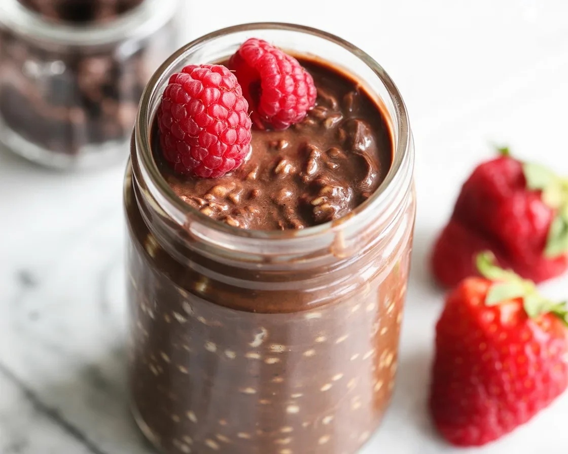 Delicious Chocolate Overnight Oats for Weight Loss topped with berries and nuts.