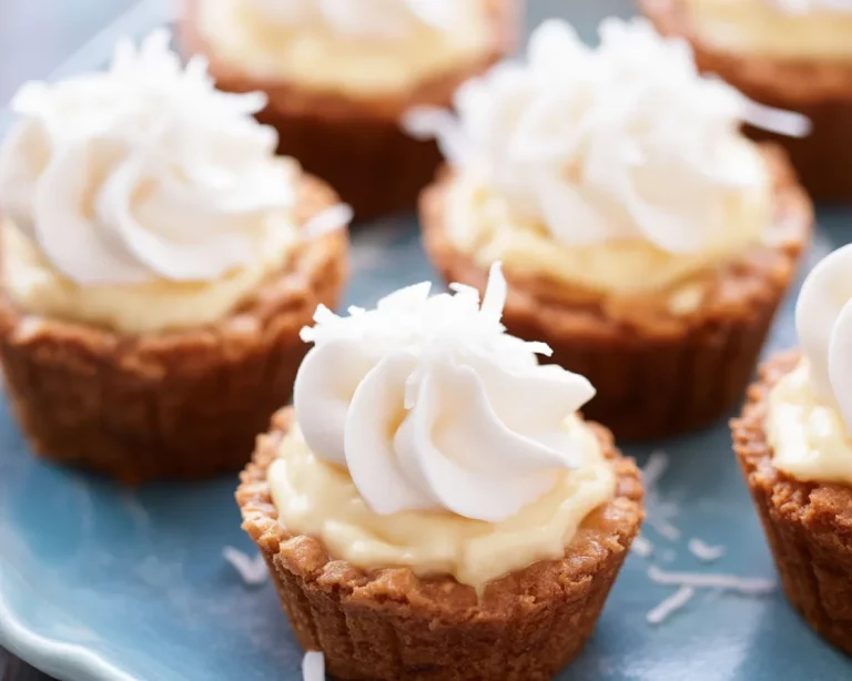 Old-Fashioned Coconut Cream Pie Cups topped with toasted coconut and meringue.