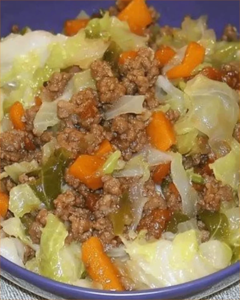 Easy ground beef with cabbage dish served on a plate with fresh herbs