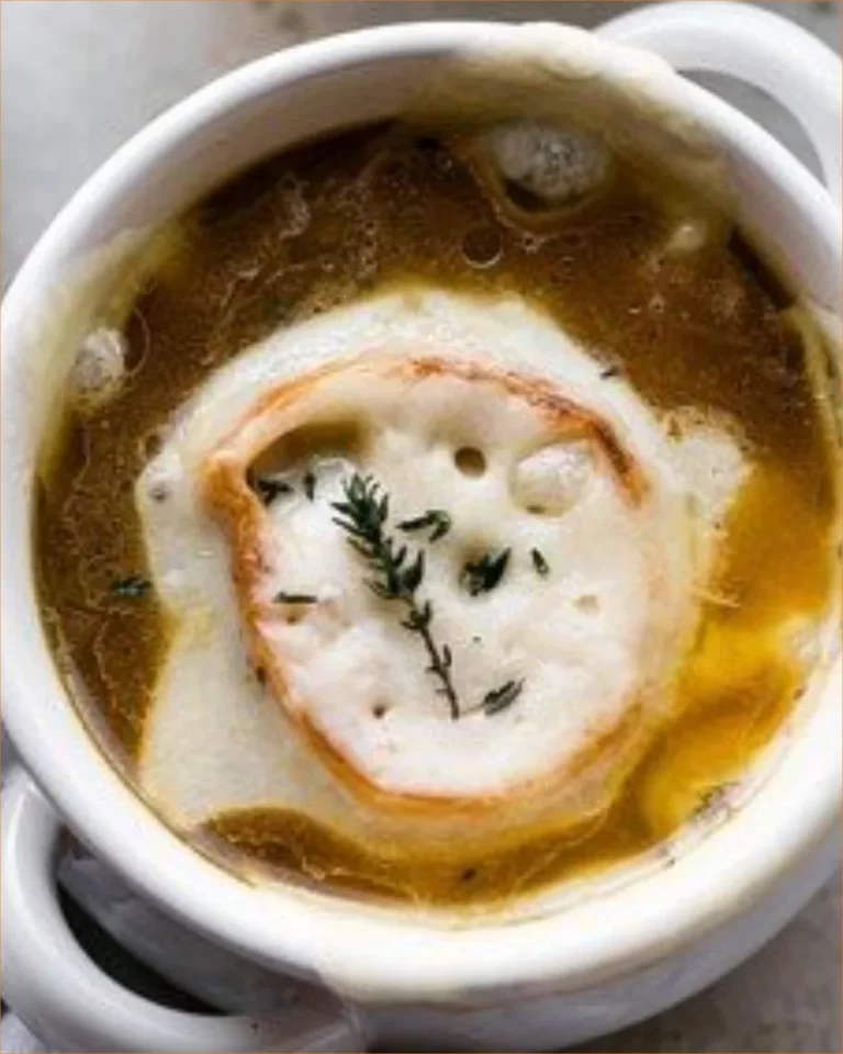 A delicious serving of French Onion Chicken Soup topped with melted cheese.