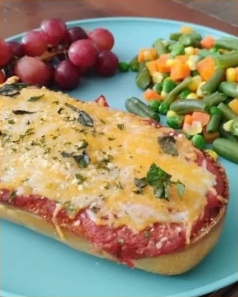 Delicious homemade French bread pizza topped with cheese and fresh ingredients.