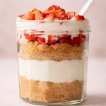 No-Bake Vanilla Protein Cheesecake Jars with layers of creamy cheesecake and fresh toppings.