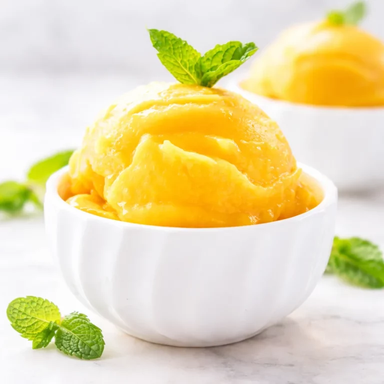 Delicious No-Sugar Added Mango Lime Sorbet served in a glass, perfect for a refreshing snack.