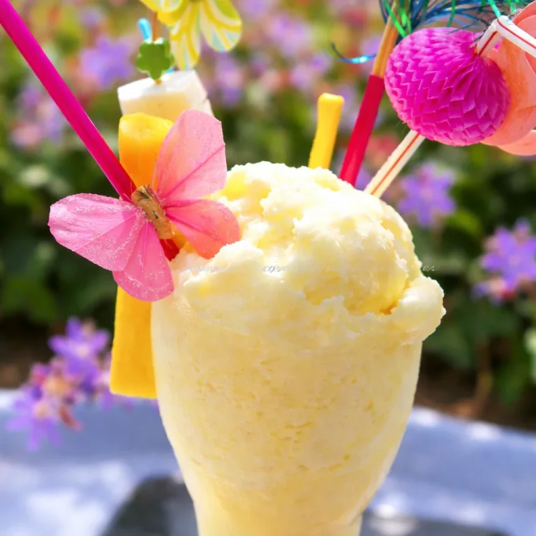 Delicious small-batch pineapple coconut sorbet in a bowl, garnished with coconut flakes.
