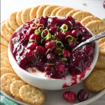 Cranberry Jalapeno Cream Cheese Dip served in a bowl with crackers