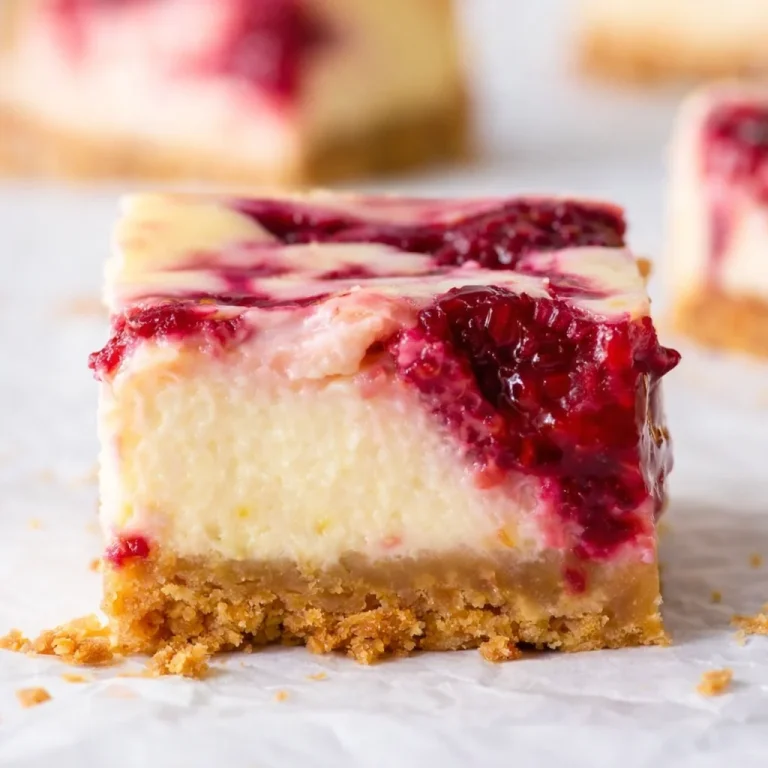 Small-Batch Raspberry Cottage Cheese Cake topped with fresh raspberries and cream.
