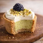Mini Blackberry Pistachio Cheesecake Cups topped with blackberries and pistachios.