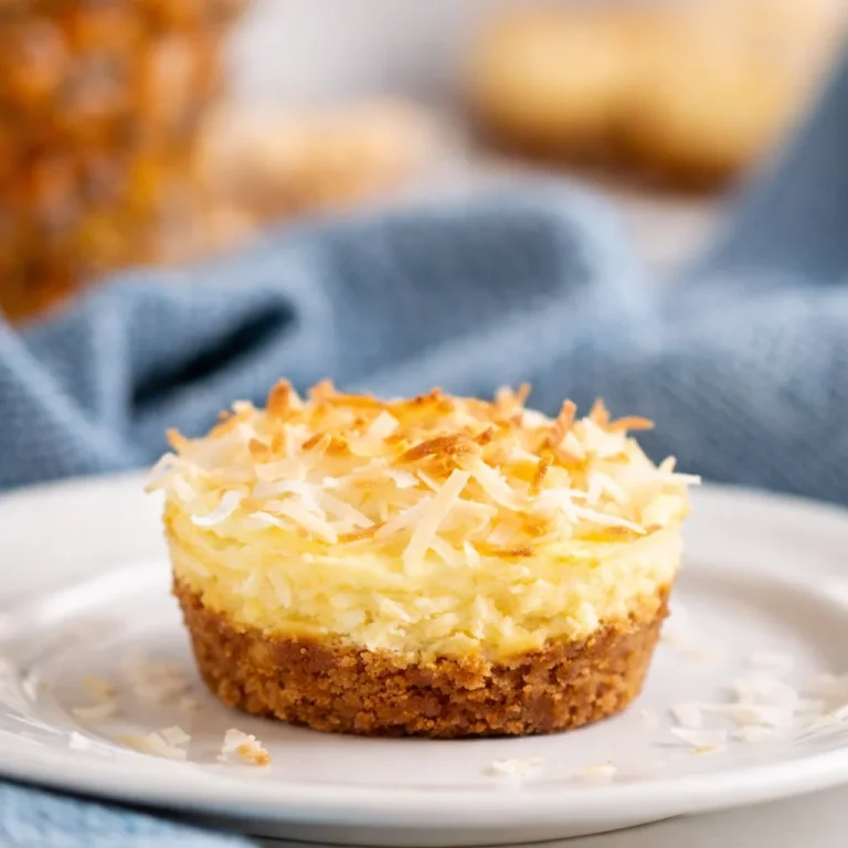 Delicious Mini Pineapple Coconut Protein Cheesecakes with creamy filling and coconut topping.