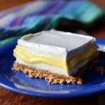 Lemon Icebox Delight dessert served in a glass, featuring lemon zest and whipped cream.
