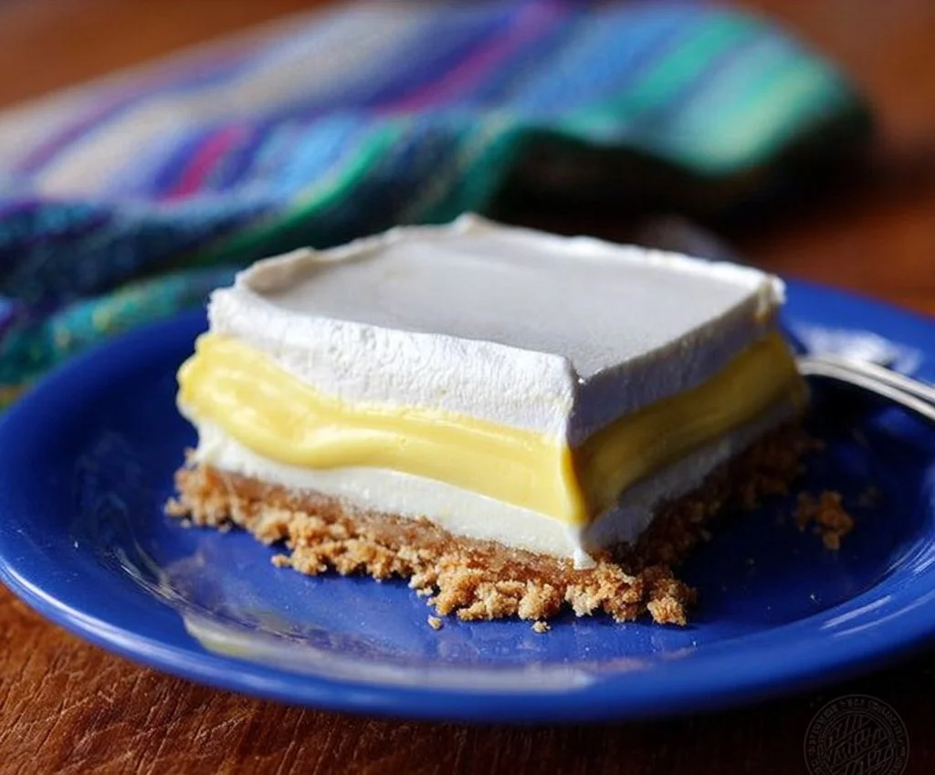Lemon Icebox Delight dessert served in a glass, featuring lemon zest and whipped cream.