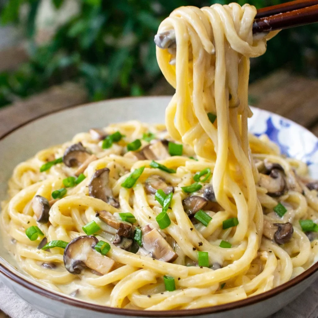 Japanese Miso Butter Mushroom Udon with thick udon noodles in creamy sauce.
